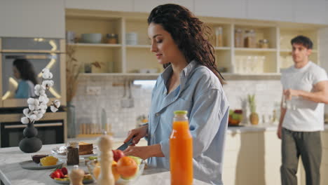young pair preparing breakfast together at home kitchen close up. happy marriage