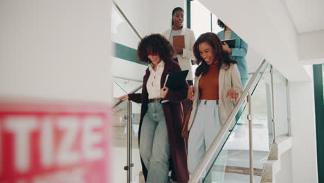 businesswomen walking up the stairs in an office building