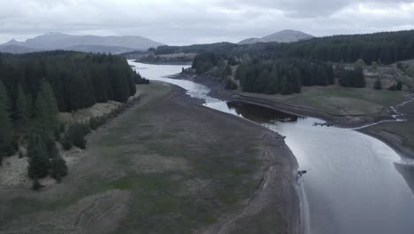 flight over a river with mountains at the horizon