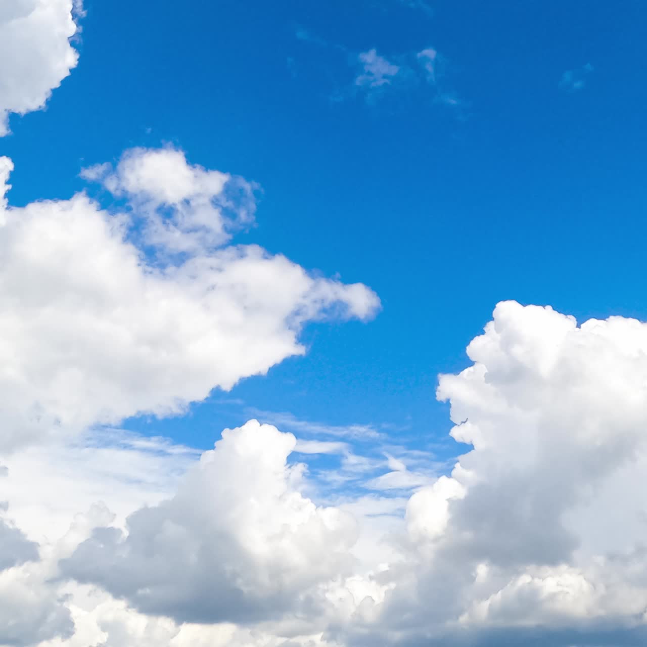 Heavenly beautiful turquoise skies with fluffy clouds quickly transforming in the wind. Spindrift clouds at backdrop. Timelapse