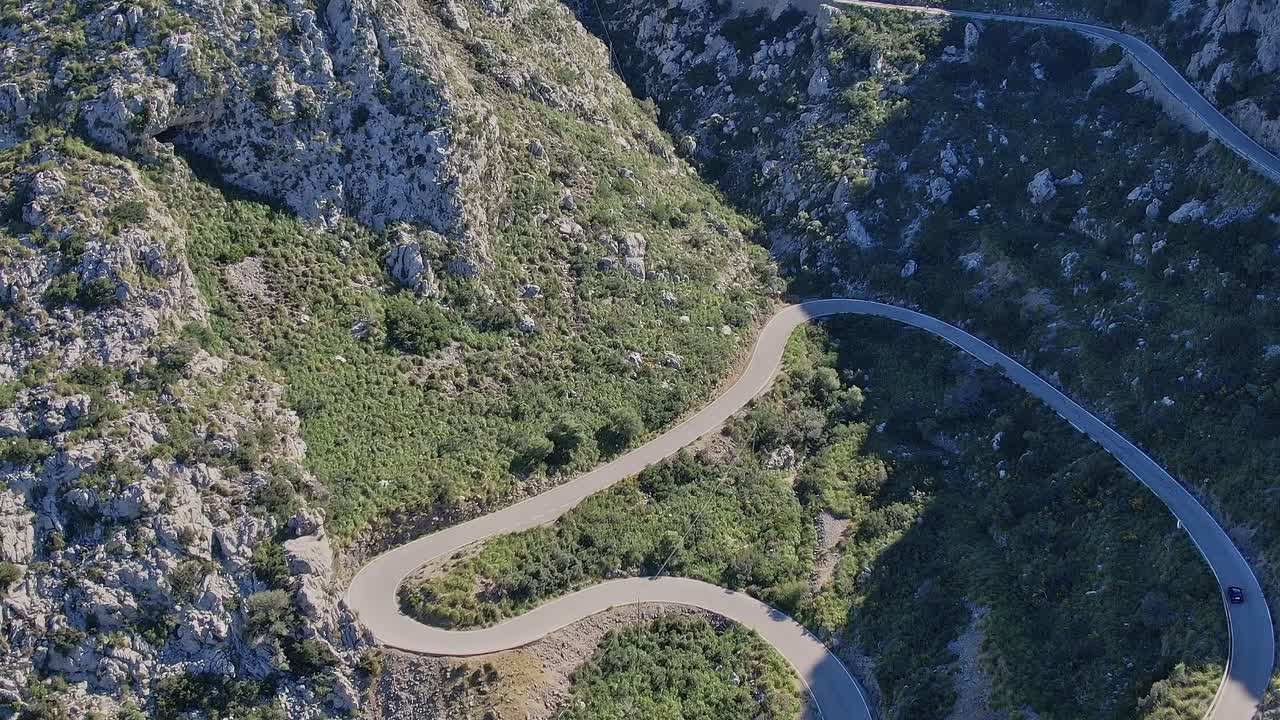 Winding road near the mountains in Mallorca Spain with green scenery