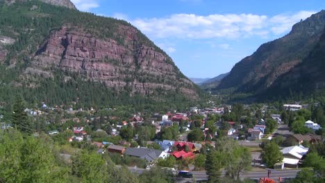 a downtown establishing shot of ouray colorado with steam train passing 1