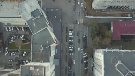 urban aerial view of cityscape with buildings, roads, and cars