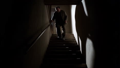 a man walking down a dark staircase
