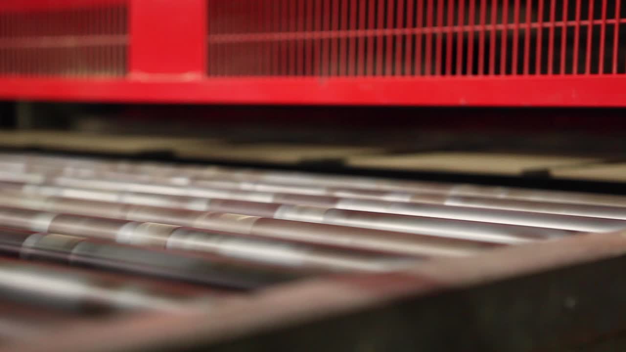 Close up view of ceramic tiles moving on transporting conveyor belt in factory