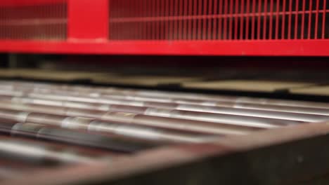 close up view of ceramic tiles moving on transporting conveyor belt in factory