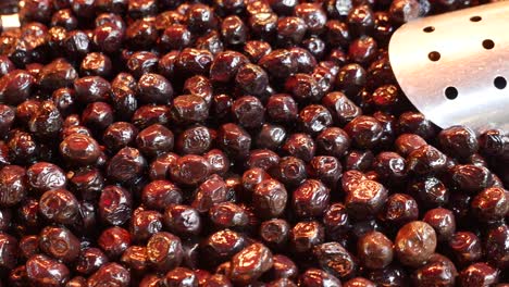 close up of black olives at a market