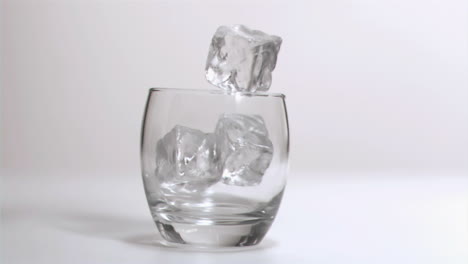 ice cubes falling in super slow motion in a glass