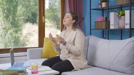 Muslim-young-woman-praying-in-front-of-the-window.