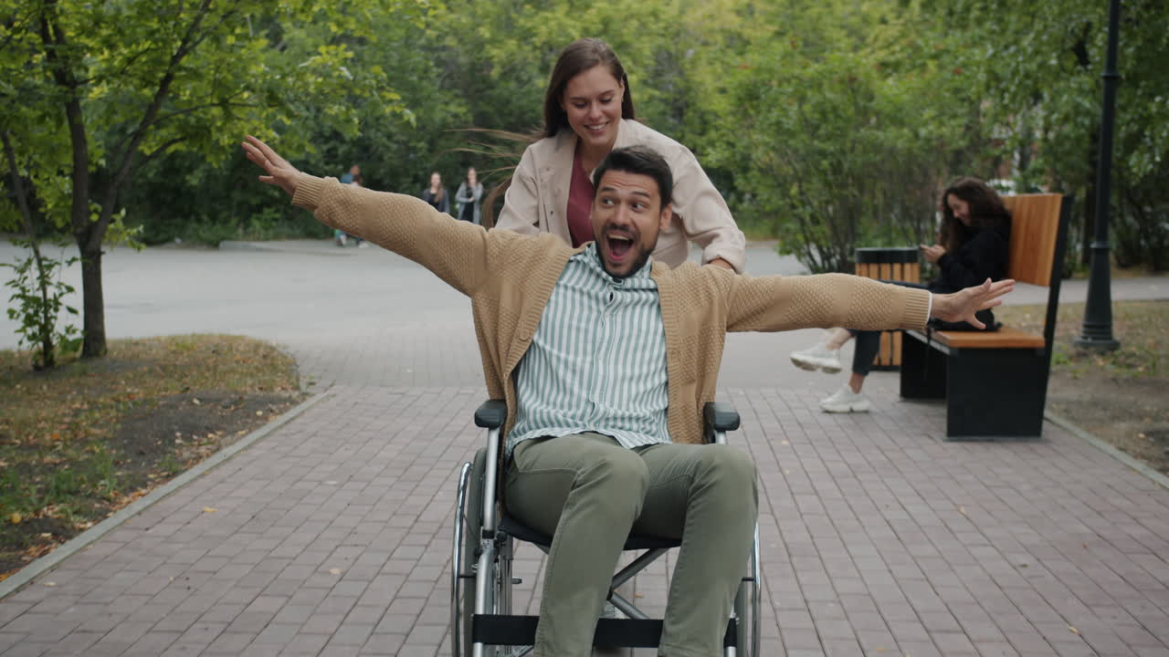 Couple in a park with a wheelchair