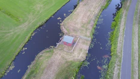 A fly-up-tilt-down shot of a small pumping station (water) in Leek, The Netherlands.