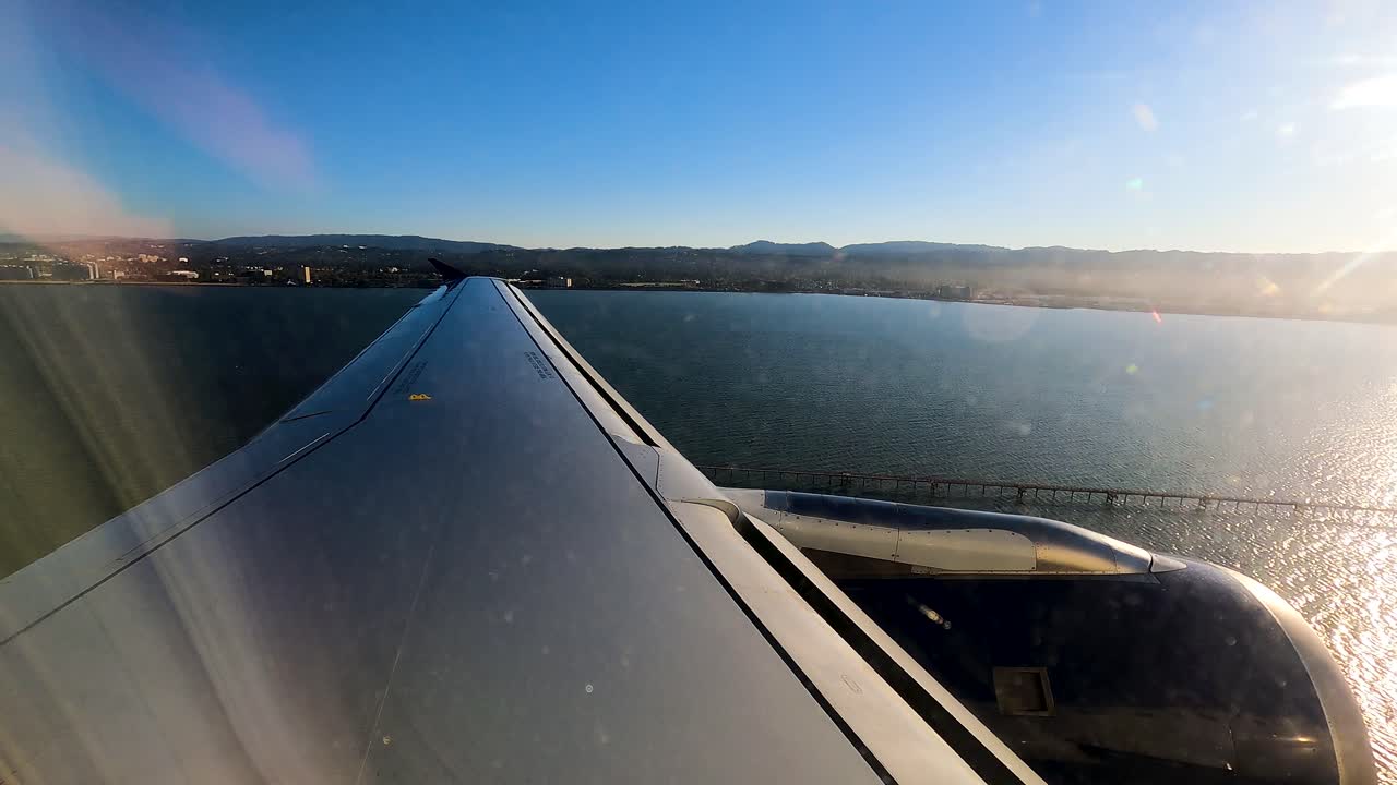 Coming in for a landing at the San Francisco International Airport in California - hyper lapse from plane window with wing in view