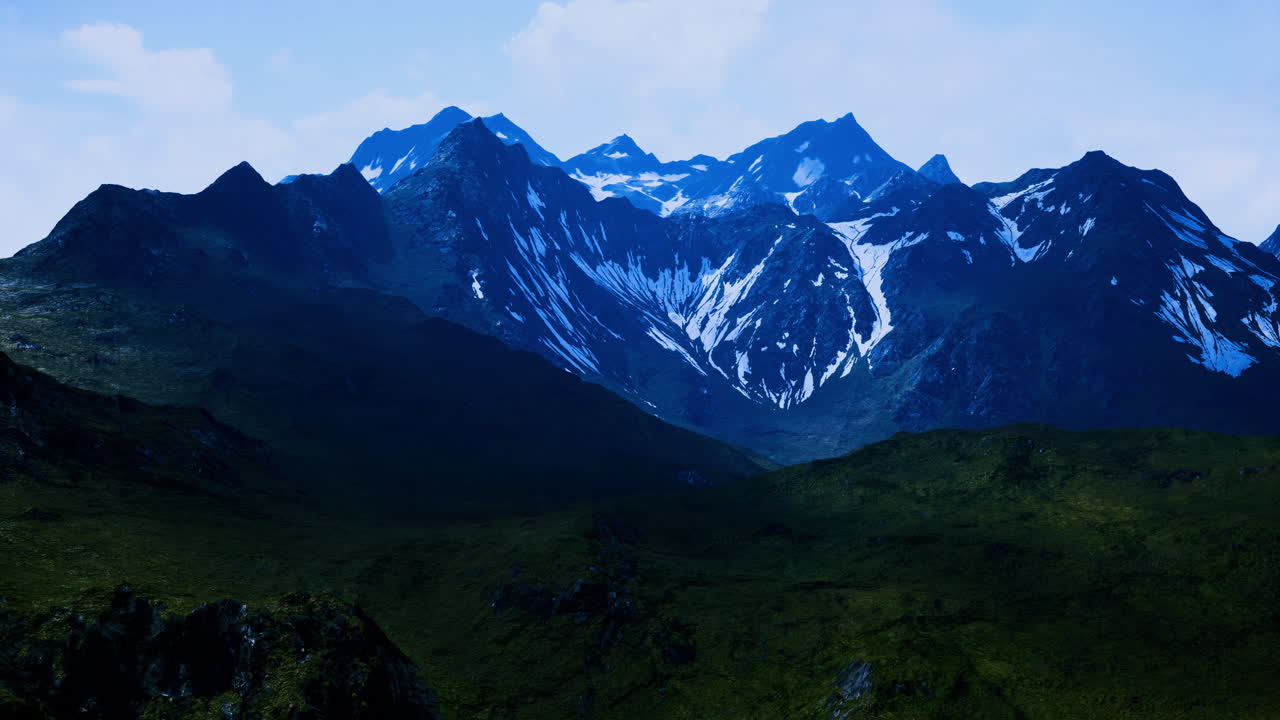 Majestic mountains rise under a brilliant blue sky in the heart of nature