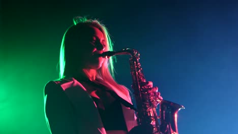 woman playing saxophone on stage