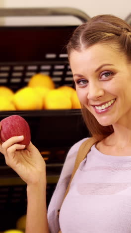 young happy woman holding apple