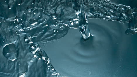 cold water pouring glass top view closeup. transparent drink filling glassware