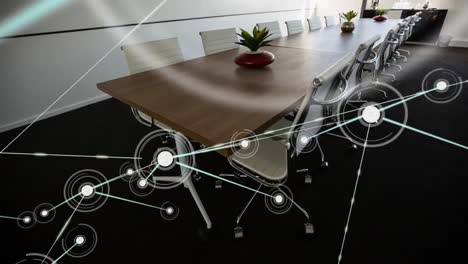 Animation-of-network-of-connections-against-empty-meeting-room-at-office