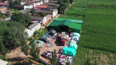 a truck unloading old clothes for recycling in a hebei village, sunny day aerial shot in china