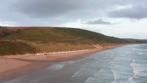 falling aerial shot of a sandy beach at sunset