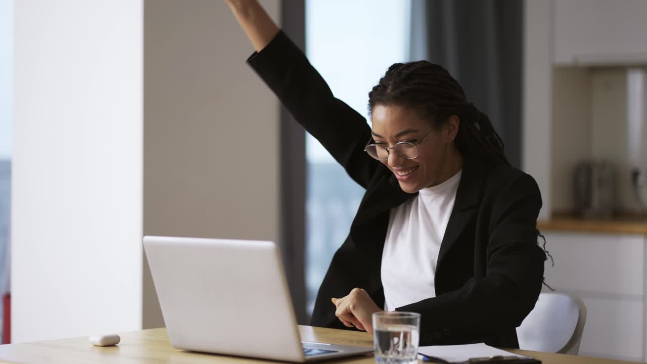 Pretty african business woman working in office on successful project