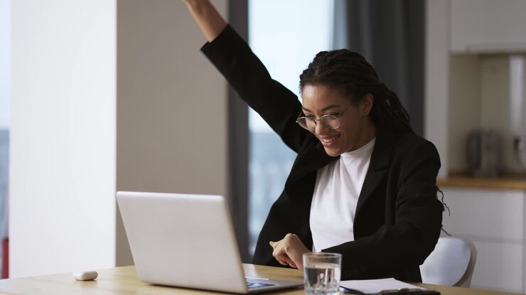Pretty african business woman working in office on successful project