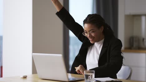 pretty african business woman working in office on successful project