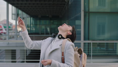 portrait of lively young business woman enjoying corporate lifestyle catching food in mouth laughing cheerful in city