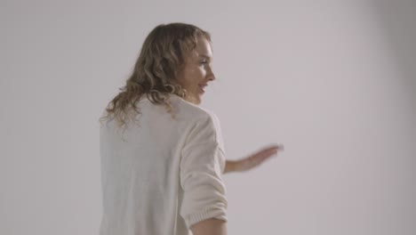 studio shot of young woman having fun dancing against white background 1