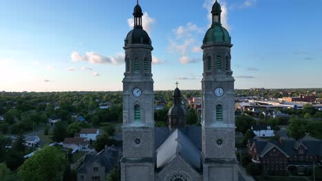 an aerial view of the saint stanislaus b and m roman catholic church spires in buffalo, new york in the light of the setting sun