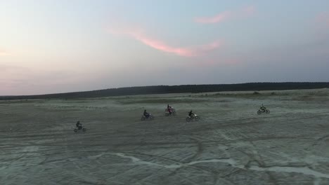 sunset dirt bike riding in a desert landscape