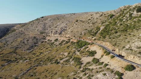 Aerial-view-of-beautiful-mountain-road-near-Stara-Baska-Beach-on-Krk-island-in-Croatia-at-sunset