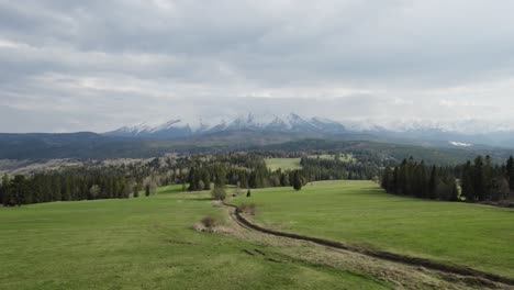 drone flying forwards though tatra mountains in vast natural terrain