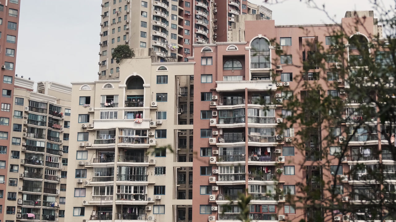 High-rise residential apartment buildings in Shanghai showcase dense urban living with balconies, air conditioners, and laundry hanging outside