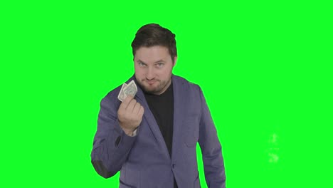 bearded caucasian actor playing with paper money in front of camera alpha channel green screen