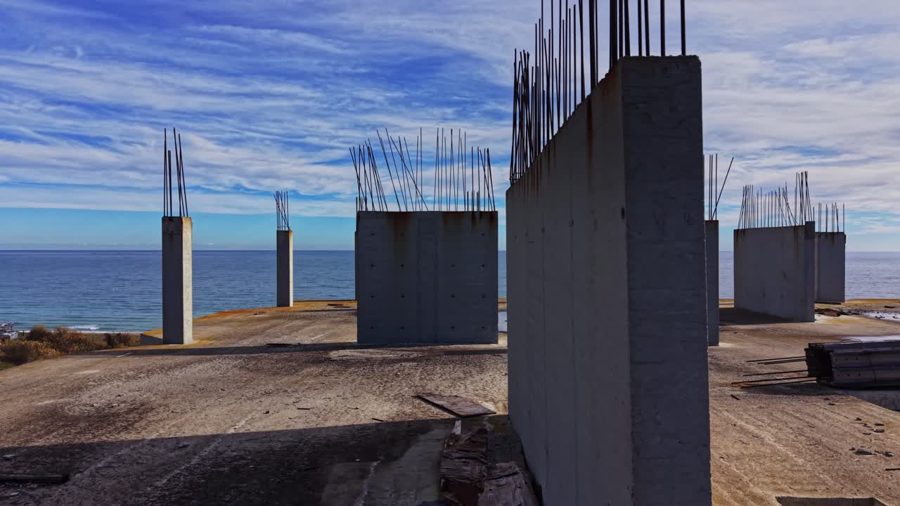 Coastal construction site with concrete foundations overlooking the sea