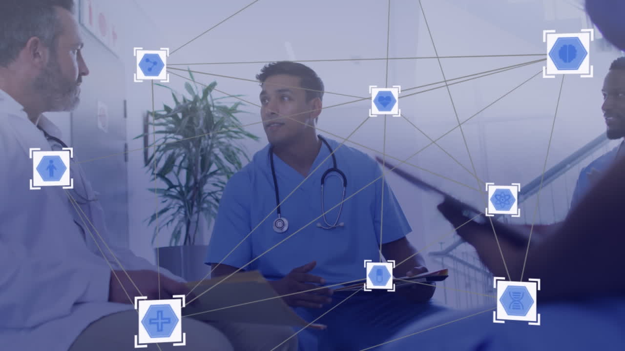 Animation of network of media icons over diverse group of doctors discussing in meeting