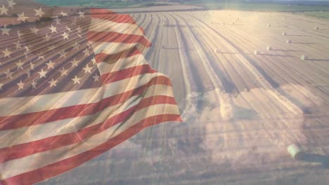 animation of flag of america blowing over ploughed field with hay bales