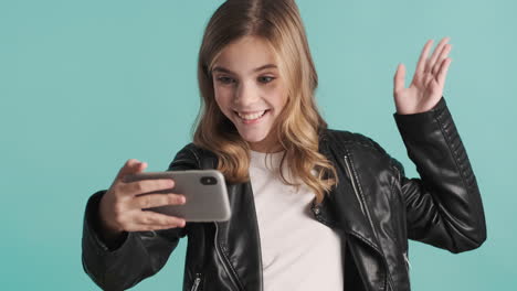 Teenage-Caucasian-girl-video-calling-on-her-smartphone.