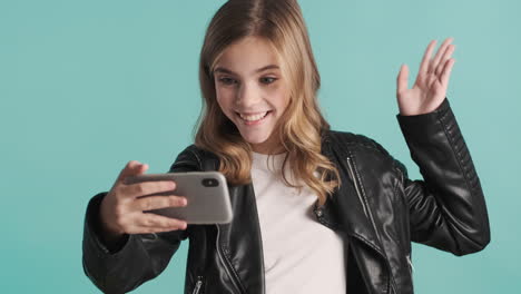 teenage caucasian girl video calling on her smartphone.