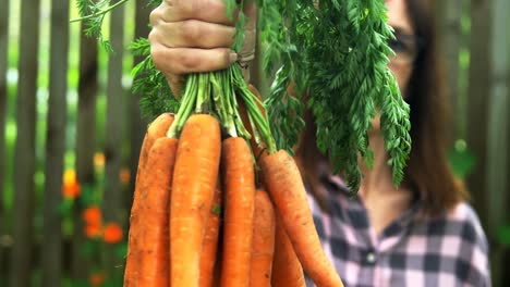 mature woman holding carrot vegetable 4k