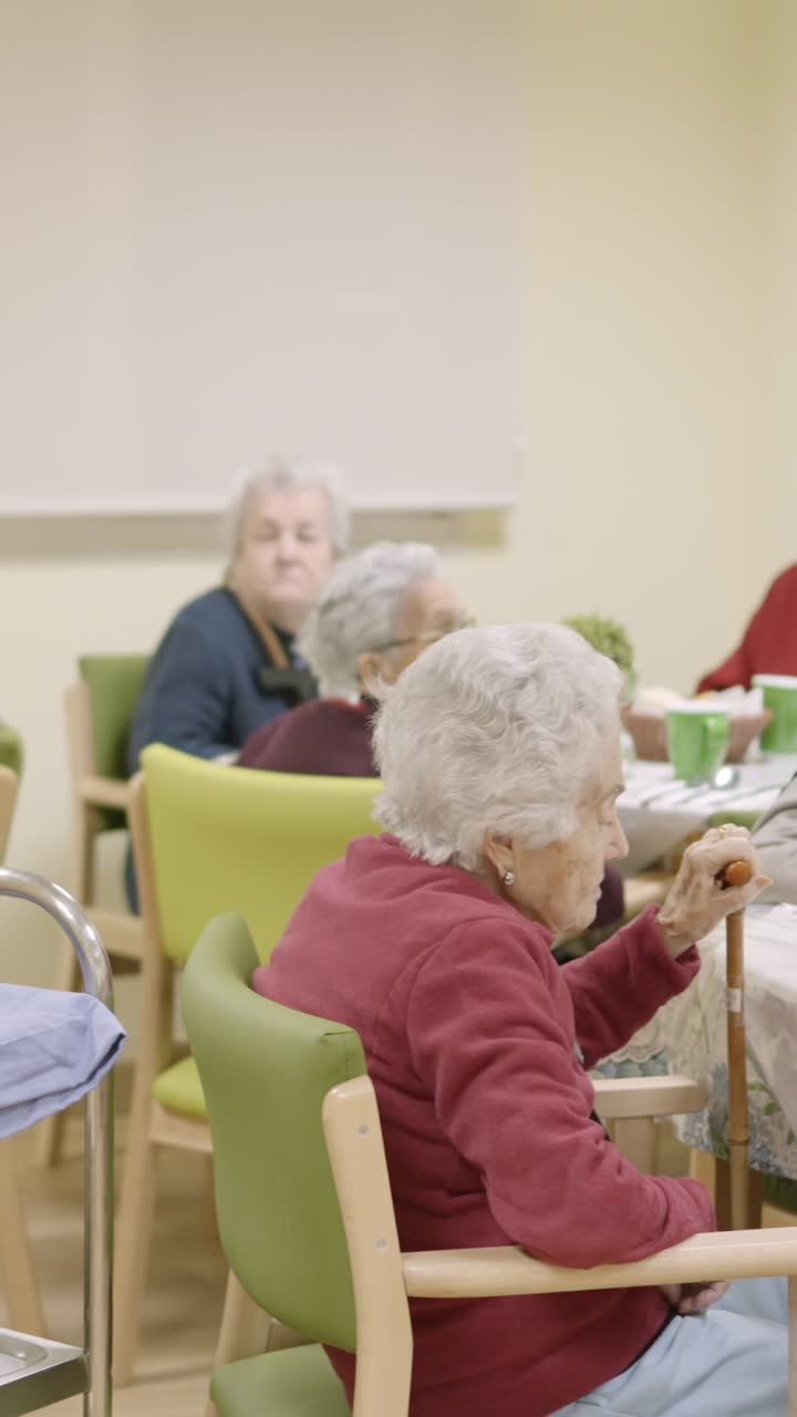 Cook entering with food to the dining room of geriatric