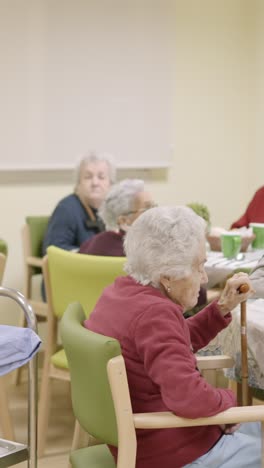 cook entering with food to the dining room of geriatric