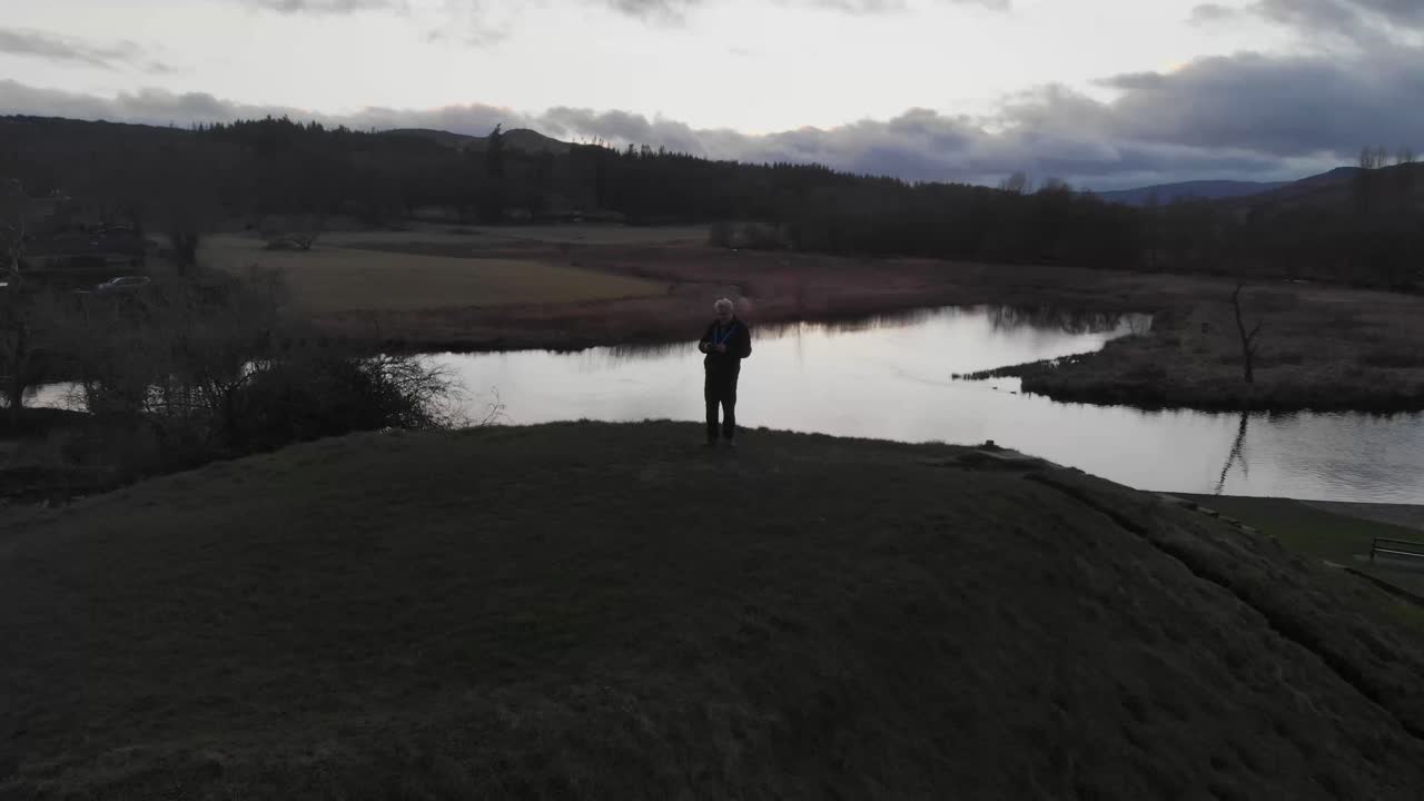 Drone flight over a Scottish loch in a sunset