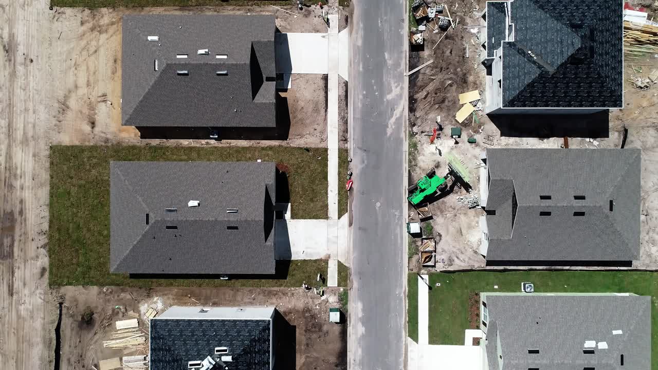 Aerial views of a residential neighborhood under construction.