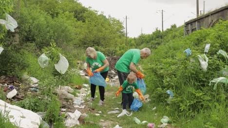 Volunteer-team-cleaning-up-dirty-park-from-plastic-bags,-bottles.-Reduce-trash-cellophane-pollution