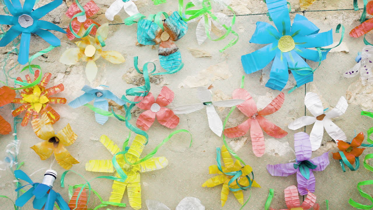 Recycled Plastic Flowers on a Wall