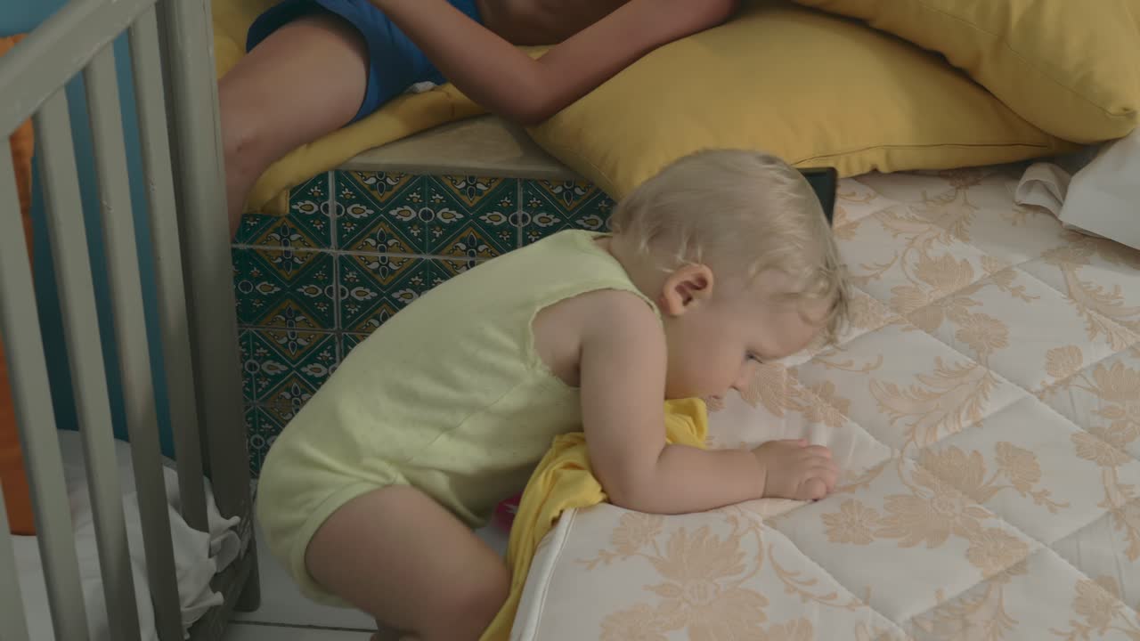 Boy and his baby sister at home