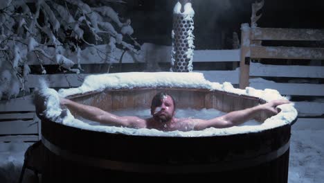 man diving in a cold bath in a outdoor pool, full of ice