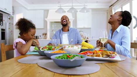 family having meal on dinning table at home