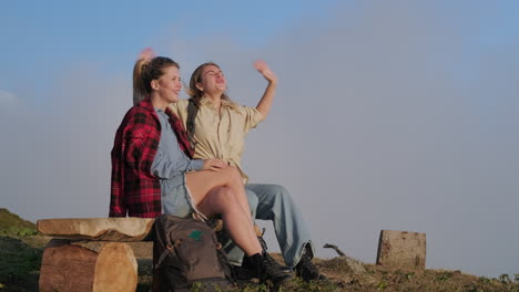 two friends enjoying the view from a mountaintop